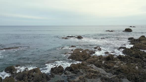 The rocky coastine at Kennack Sands, Cornwall, England gives way to a sandy beach in a popular holid