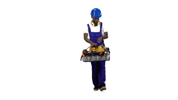 African American Construction Worker Goes To Work with a Suitcase with Tools . Alpha Channel