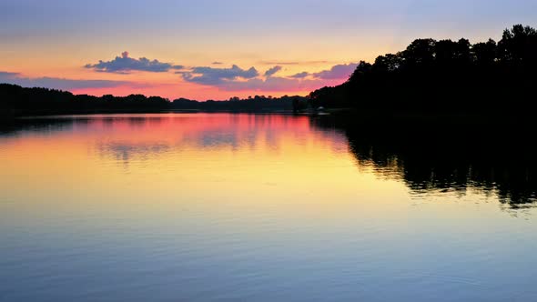 Calm sunset at the lake in summer