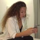Long Haired Mixed Race Lady in Shirt Types on Smartphone - VideoHive Item for Sale