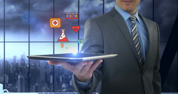 Man showing digitally generated medical icons on tablet