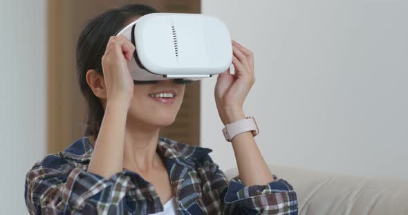 Woman watch though virtual reality device at home