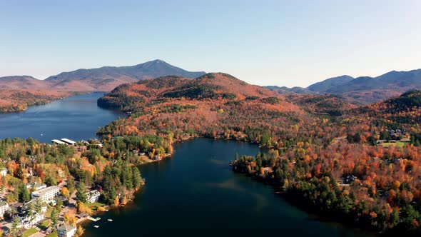 Aerial flythrough over Lake Placid and Mountains during Autumn Fall Colors in New England