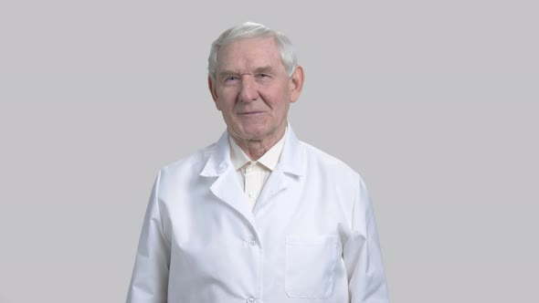 Friendly Old Senior Man in White Shirt and Coat Smiling.