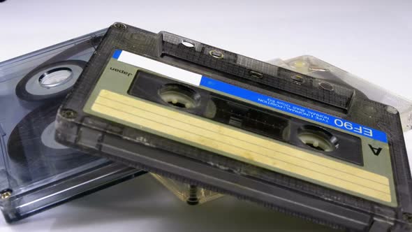 Three Vintage Audio Cassette Rotates on White Background