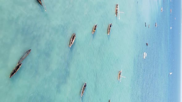 Vertical Video Boats in the Ocean Near the Coast of Zanzibar Tanzania Aerial View