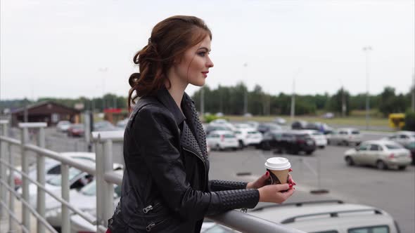 Girl Looking at the City During the Coffee Break