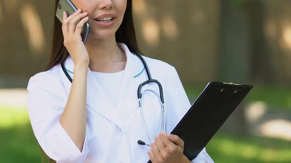 Smiling General Practitioner Talking Phone With Patient, Informing About Results