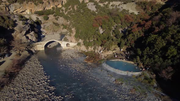 Drone view of people swimming and bathing in hot springs