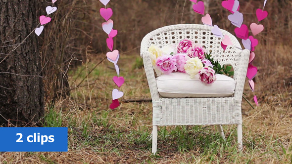 White Chair and a Garland of Paper Hearts  