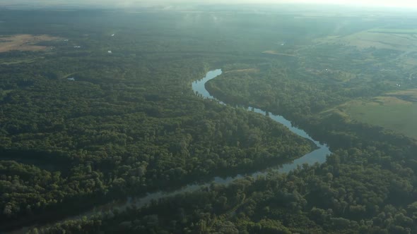 Aerial View of Winding River in Forest