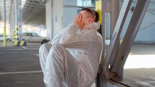 Despair Healthcare Worker in White Covid Protective Overalls