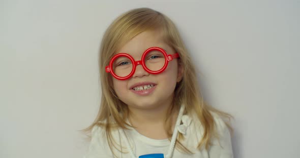 Little Child Girl Wear Red Glasses Holding Stethoscope Playing Game As Doctor, Happy Cute Adorable