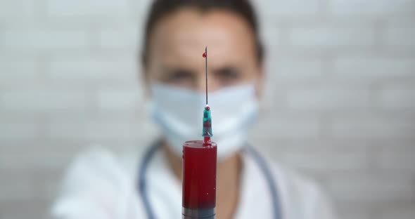 Medical worker using syringe.