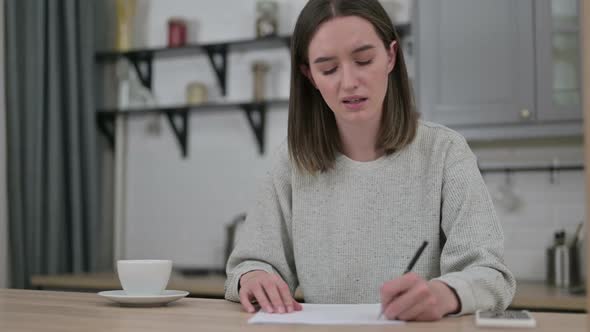 Hardworking Young Woman Failing to Do Paperwork at Home