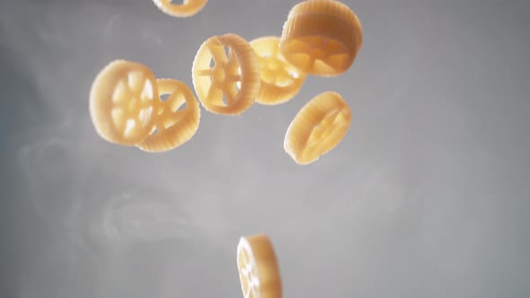 Camera follows cooking insalatonde pasta in boiling water. Slow Motion.