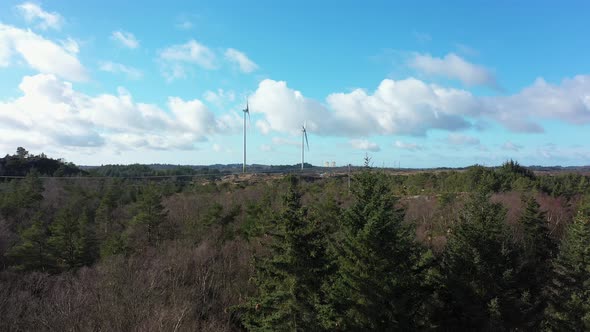 Two huge wind turbines in Lindesnes wind park southern Norway - Aerial with parallax effect and spru