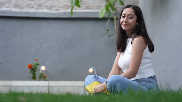 Woman Looking at Camera in Garden