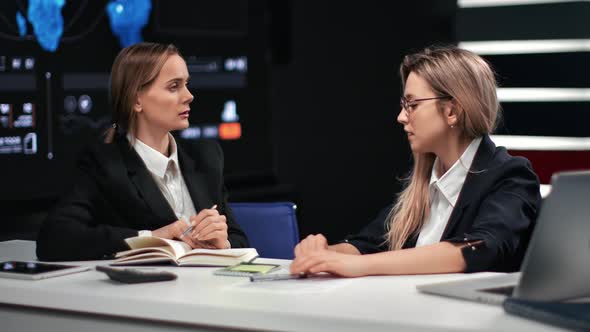 Two Business Woman Talking Making Notes at Formal Business Meeting