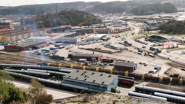 Swedish Freight train slowly moving along tracks amidst a busy highway in Uddevalla Sweden