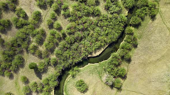 Aerial Of A Winding River Through A Meadow