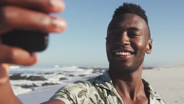 African American taking selfie seaside