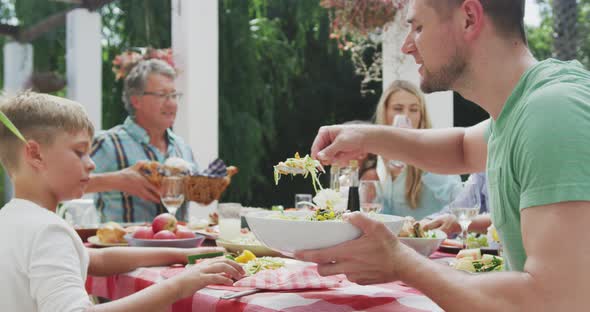 Happy family eating together at table