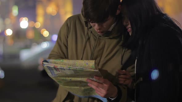 Young Couple Lost in City and Searching the Way, Sightseeing, Vacation Abroad