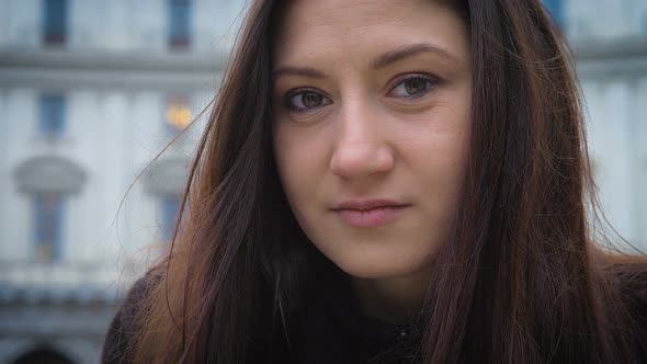 Beautiful Relaxed Young Woman Looking at Camera