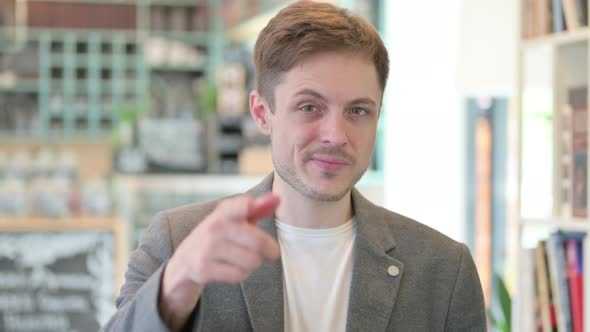 Portrait of Young Man Pointing at the Camera