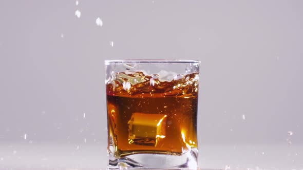Whisky Splash Isolated on a White Background. Slow Motion. Close Up
