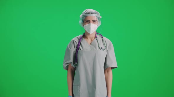 Portrait of Young Female Doctor in Protective Gear and Medical Mask Woman Looks at the Camera and