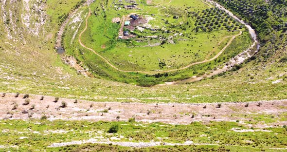 Aerial View of people admiring the landscape of the wooded hills and the paths.