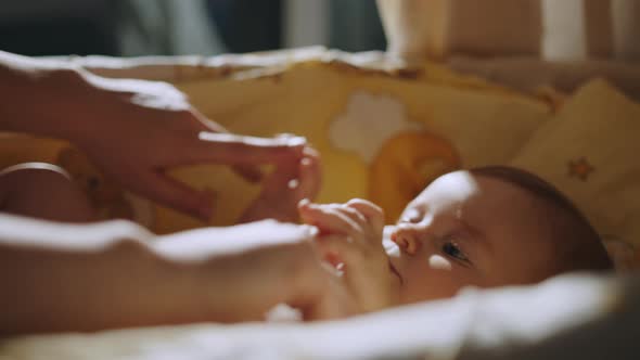 Close Up Footage of Newborn Baby Playing With Mother's Hand and Finger While