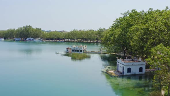 Smooth aerial view of the famous boat houses that line the lake banyoles in catalonia spain.