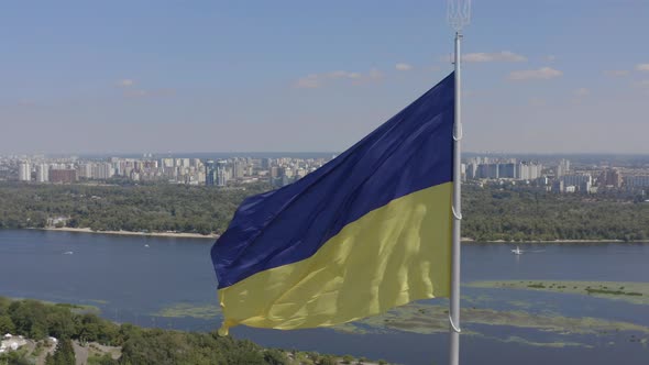 Aerial View of The Largest Flag of Ukraine is Flying Against the Backdrop of the City of Kyiv and