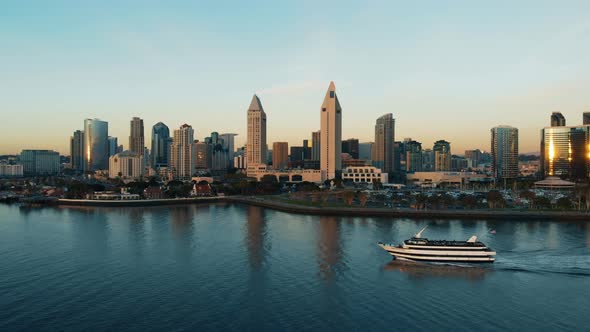 Downtown San Diego Skyline Over The Water Aerial at Sunset and Tourist Boat