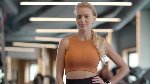 Smiling Female Athlete in Fitness Center. Fitness Woman Standing at Gym.