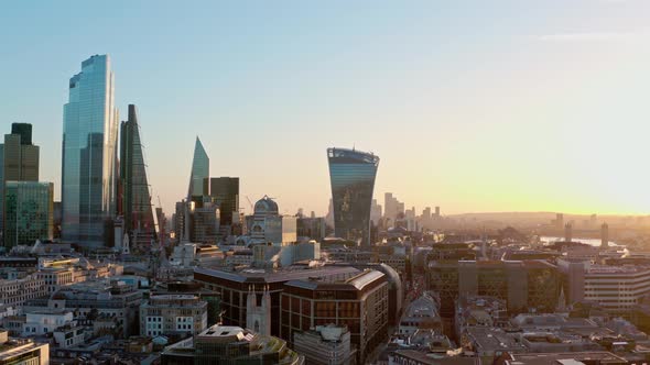 Aerial slider shot of Central London skyscraper buildings and canary wharf at sunrise