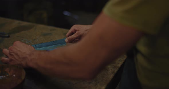 Smith is Polishing and Sharpening Old Traditional Steel Knife Closeup View of Hands  Prores