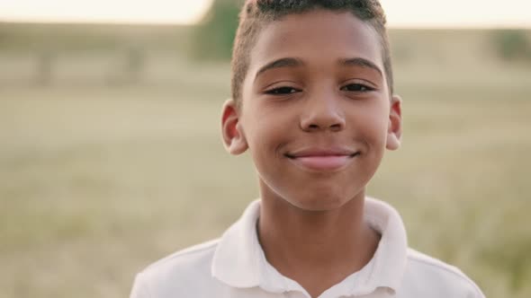 A smiling american boy is looking to the camera