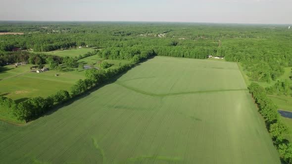 Aerial top view house in the countryside around with beautiful farm field.