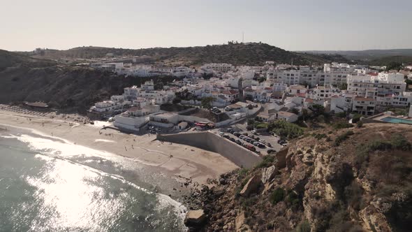 Sun kissed beach of Burgau, Algarve. Townhouses and resorts overlooking beach and oceana