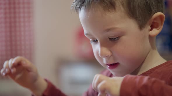 Closeup of a Boy Playing on a Tablet