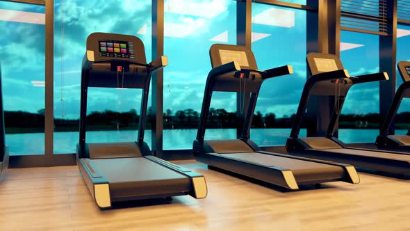 Treadmills In A Row with big windows in the background. Gym Fitness Cardio.