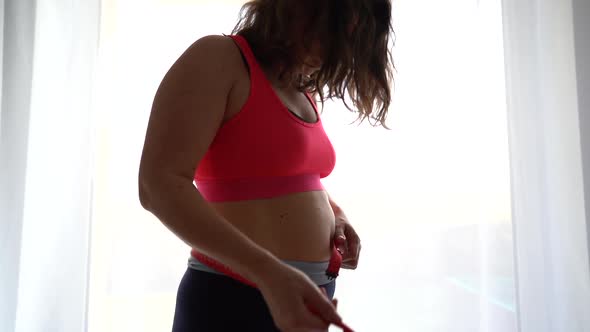 Frustrated Overweight Woman Measuring Waist