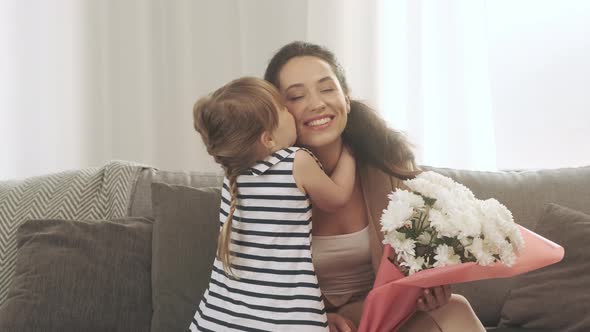 Happy Mother's Day Little Daughter Congratulates Mom and Gives Her White Flowers