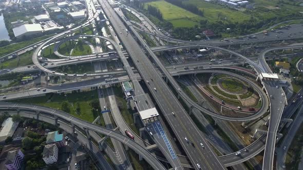 Aerial View of Highway Road Interchange with Busy Urban Traffic Speeding on Road