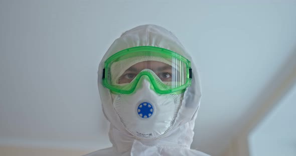 Portrait of a Medic in a Protective Suit Mask and Glasses