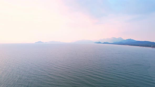 4K Aerial view of drone move on beautiful sea. sunset over ocean waves sand beach.